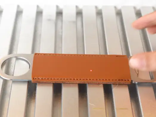 put the bottle opener on the laser bed.webp