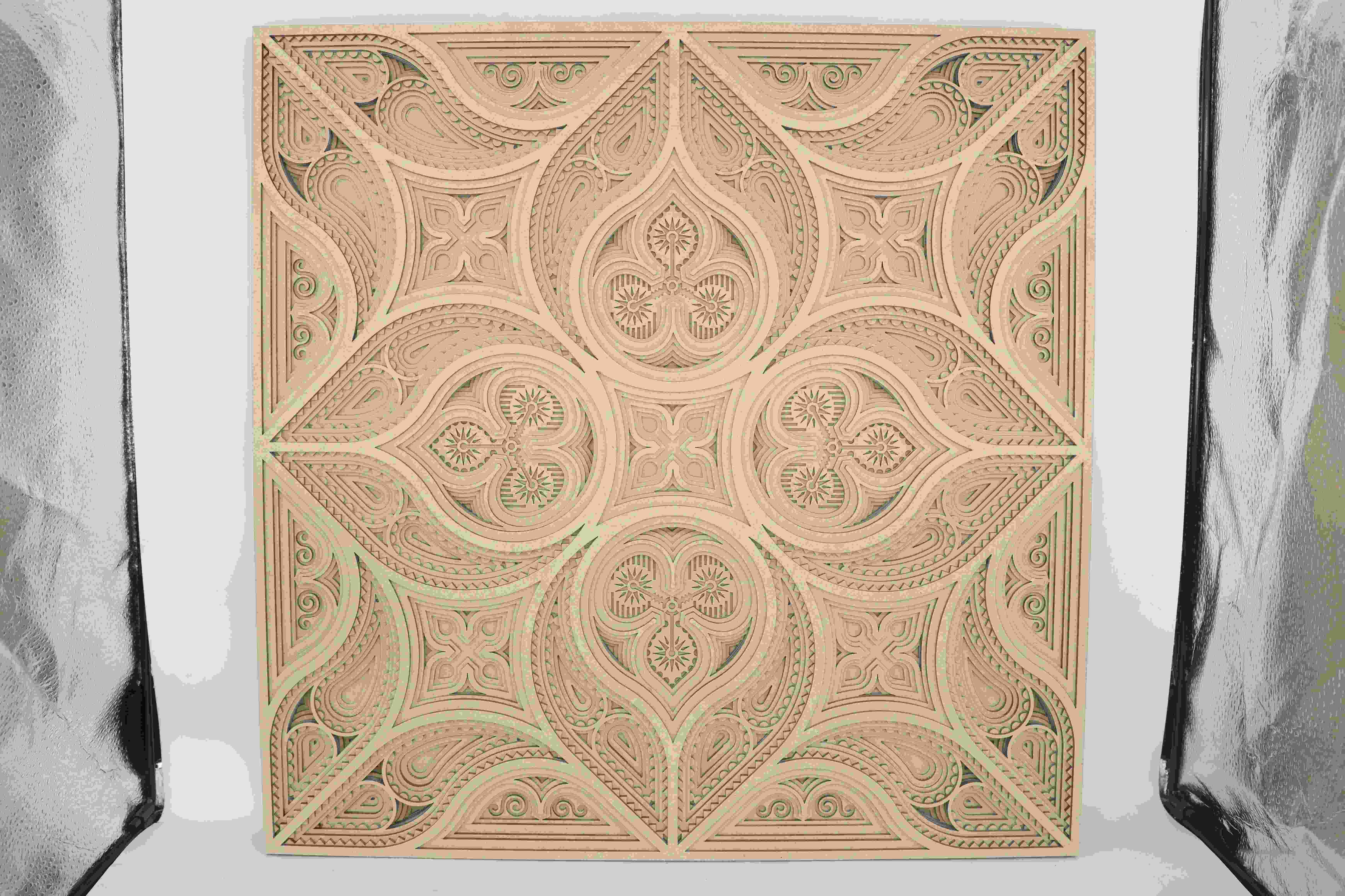 A layered wall art piece made from wood, precisely cut with a laser to form intricate patterns and clean edges A layered wall art piece made from wood, precisely cut with a laser to form intricate patterns and clean edges
